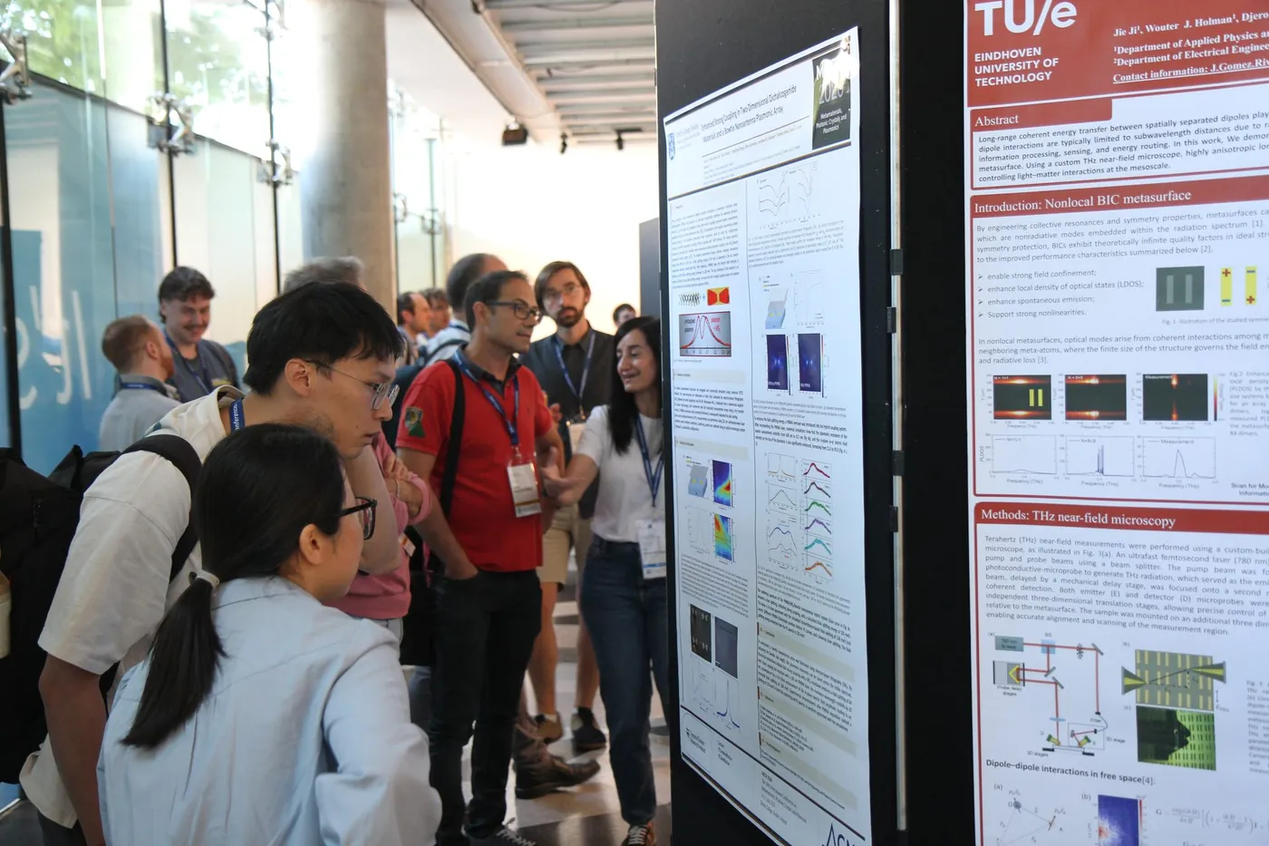 A researcher explaining a poster to a group at META 2026, Trinity College Dublin