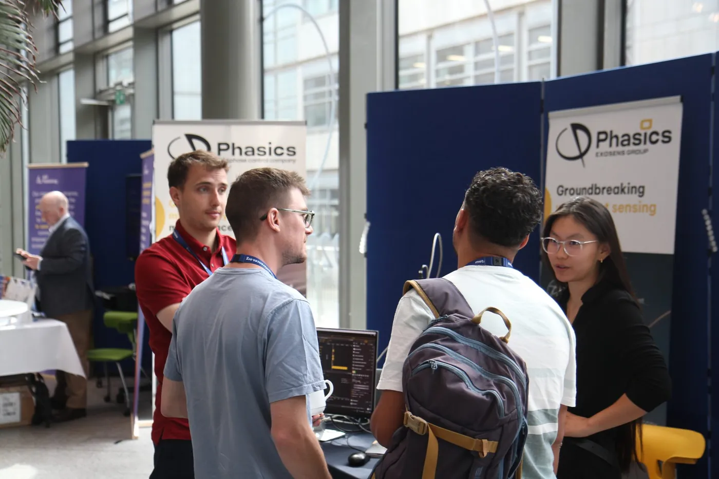 Attendees in discussion at an exhibitor stand at META 2026, Trinity College Dublin