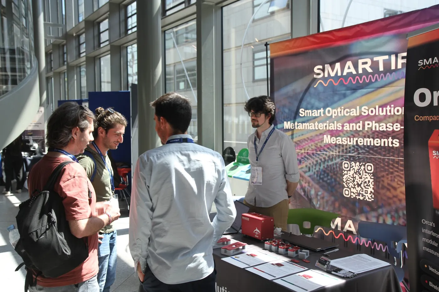 Attendees gathered at an exhibitor stand at META 2026, Trinity College Dublin